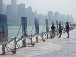 Tourists in HK contemplating outdoor painting exhibition