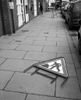 I took this photograph as part of my street photography project.  I like the candid nature of the photograph, a workman laying down on the job.