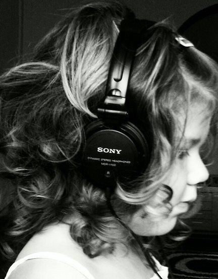 My daughter listening to some funky tunes, using my sony headphones. Cool pic!